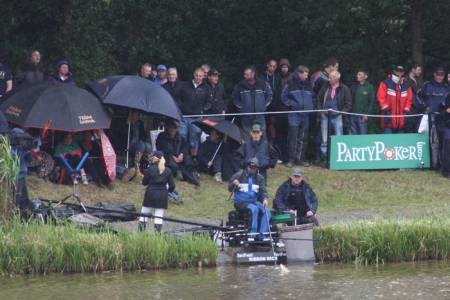 Kieron lands a fish with family and supporters looking on